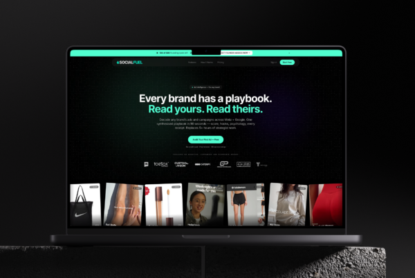 socialfuel.io — the Foreplay and AdSpy alternative — homepage on a MacBook Pro: "Every brand has a playbook. Read yours. Read theirs." with a wall of decoded competitor ads